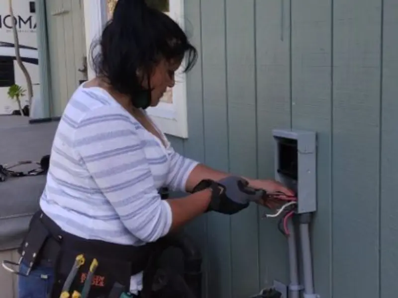 Licensed electrician wiring an exterior subpanel in Longswamp
